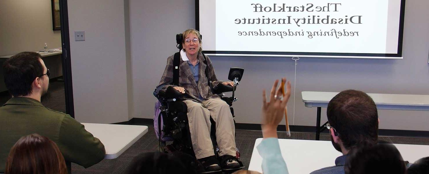 Presenter giving a lecture on disabilities in a classroom